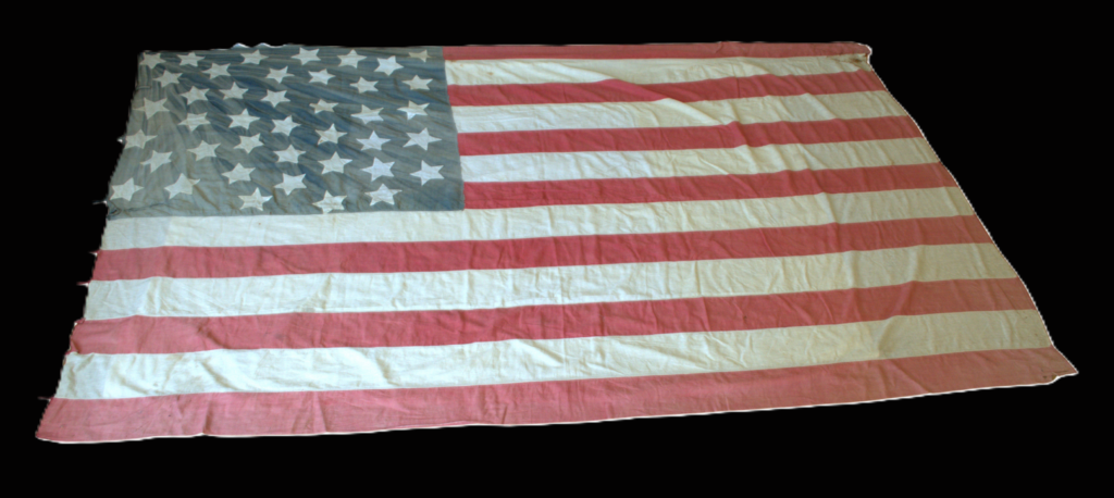 A US flag showing 41 stars against a black background.