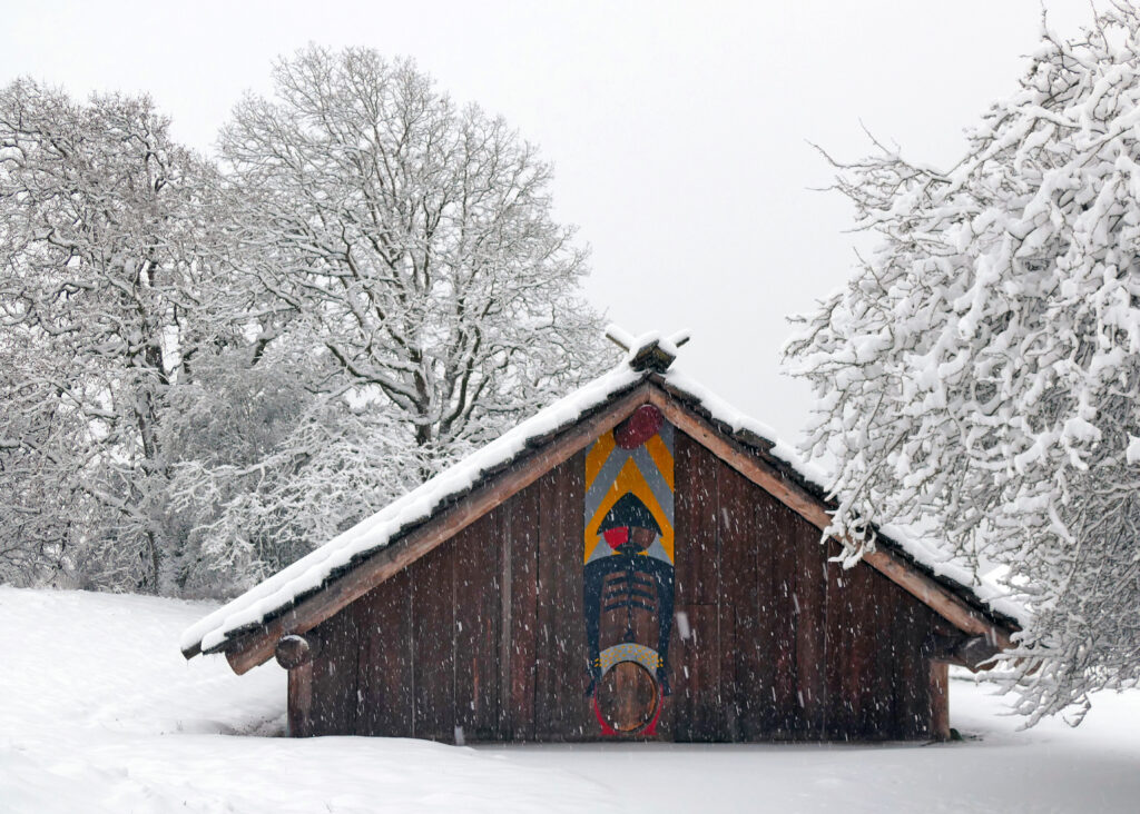 Wooden plankhouse in the snow.